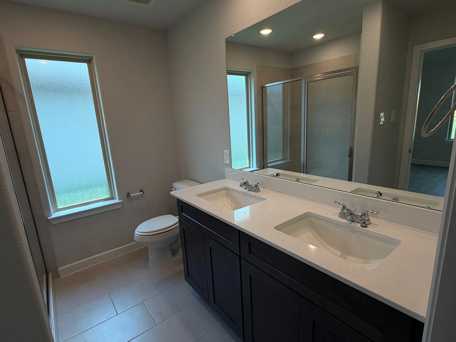 Primary bathroom with double vanity at 11858 Serena's Song Drive, Willis, TX