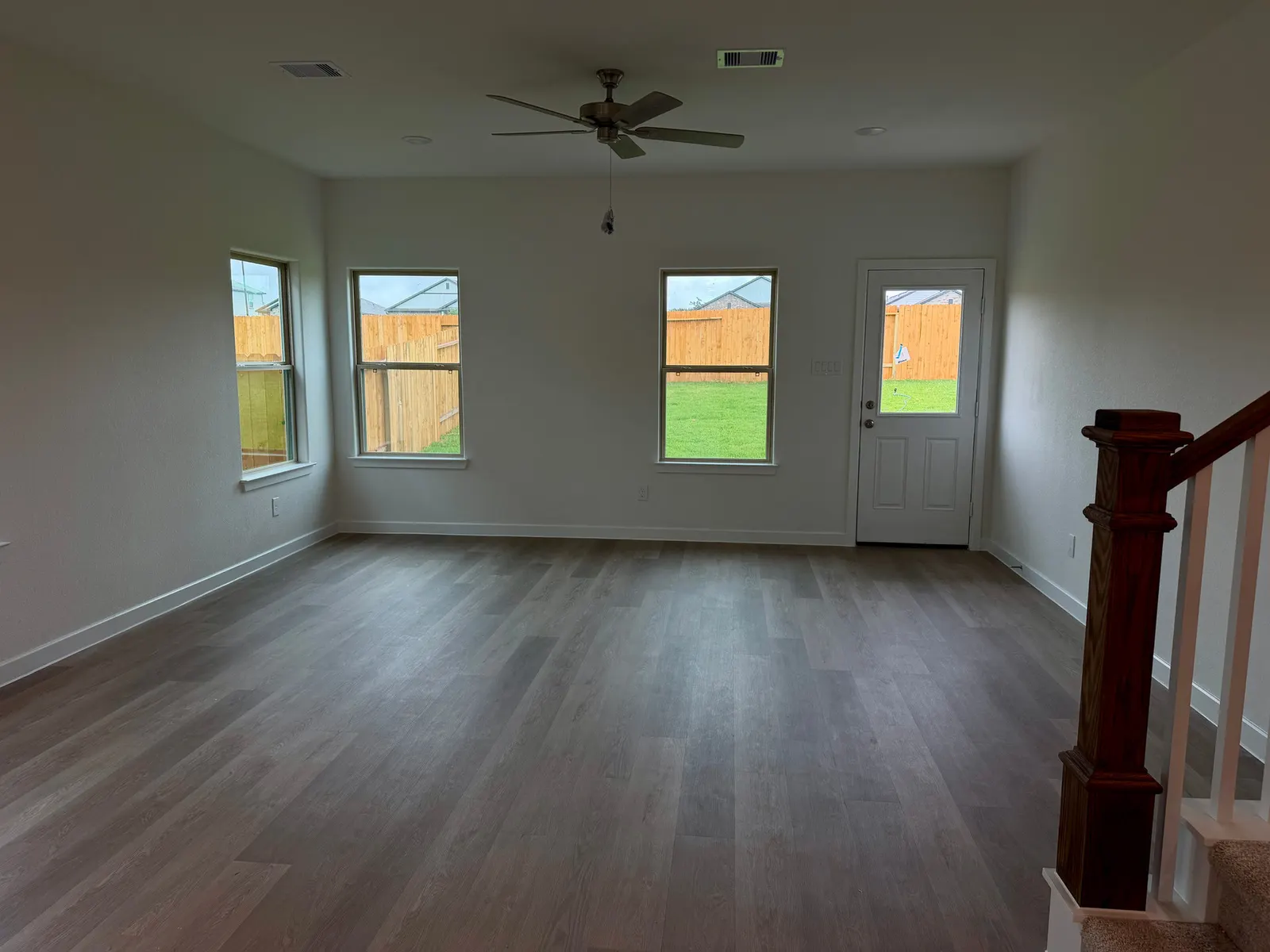 Living room with backyard windows at 11830 Serena's Song Drive, Willis, TX