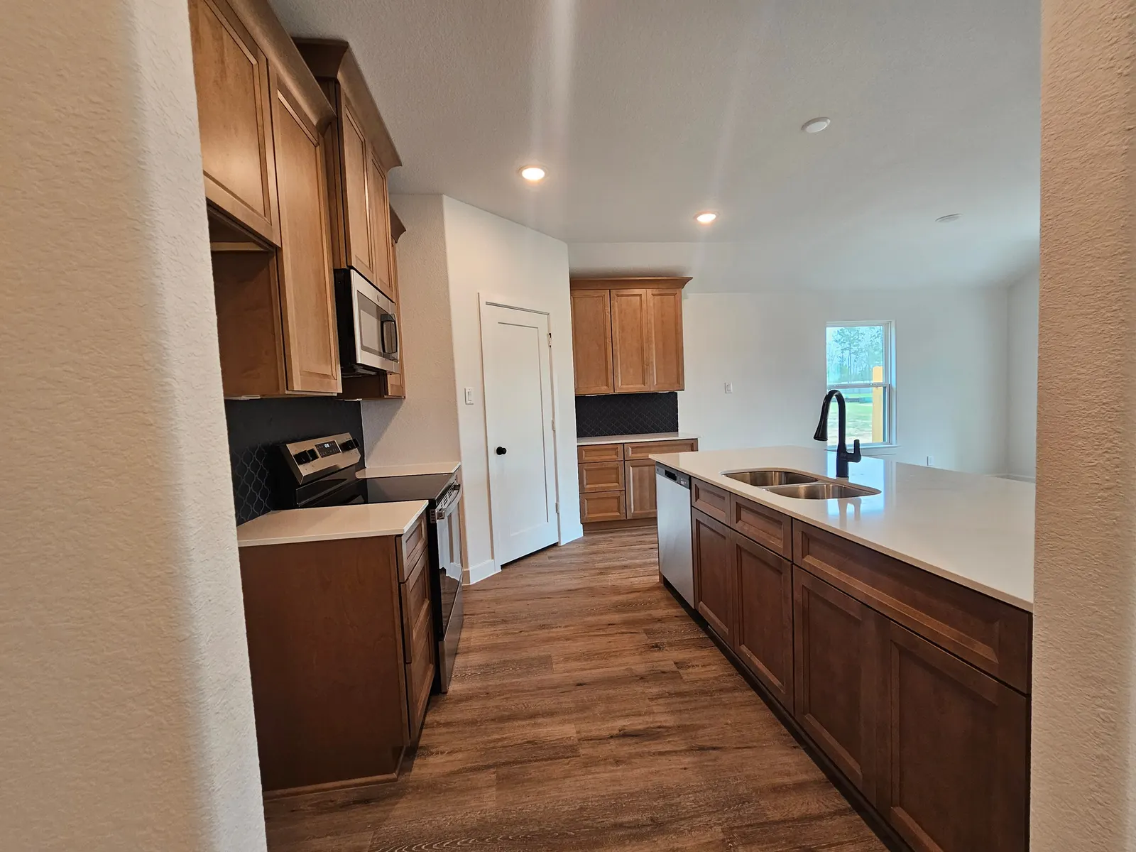Kitchen with gas range and corner pantry at 10727 Crockett Meadows, Conroe, TX