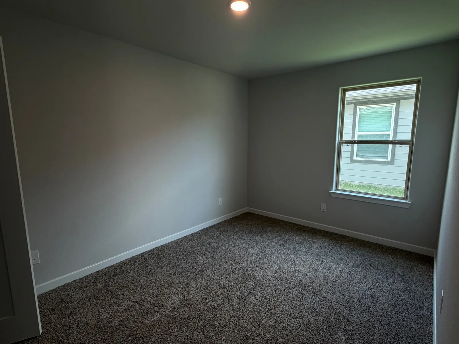 Carpeted bedroom with window at 11858 Serena's Song Drive, Willis, TX