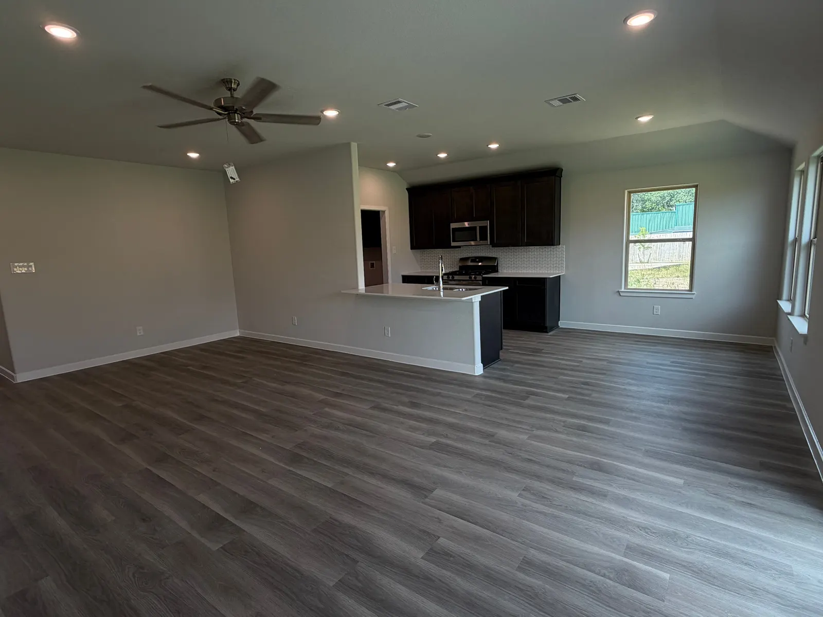 Open living area looking toward the kitchen at 11858 Serena's Song Drive, Willis, TX