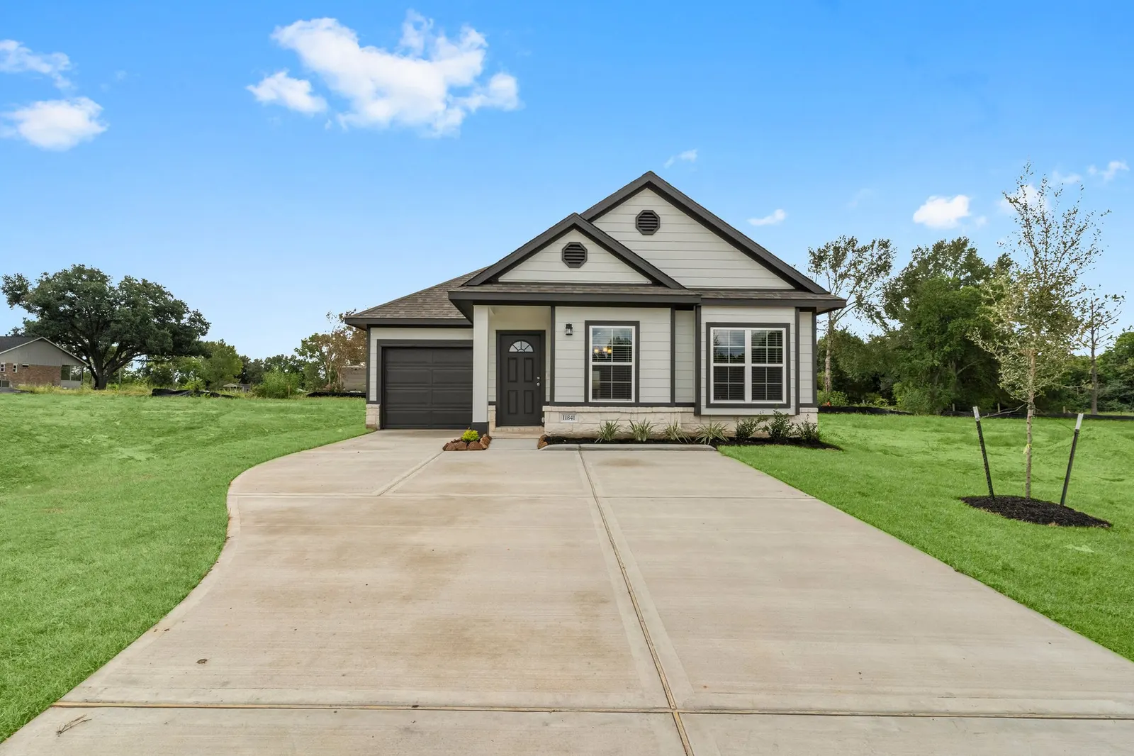 One story front exterior with driveway at Lake Conroe Village, Montgomery, TX
