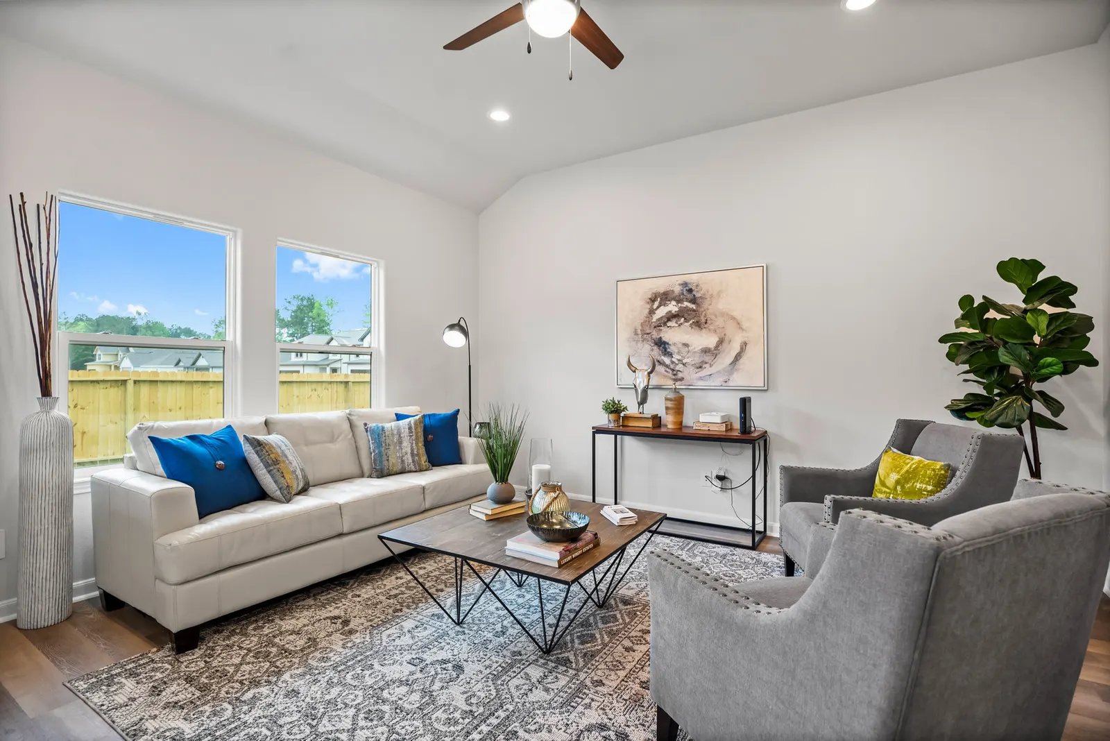 Living room in an Alta home, with windows onto the fenced back yard
