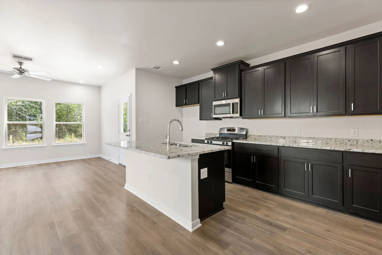 Kitchen with dark cabinets and island at Lake Conroe Village, Montgomery, TX