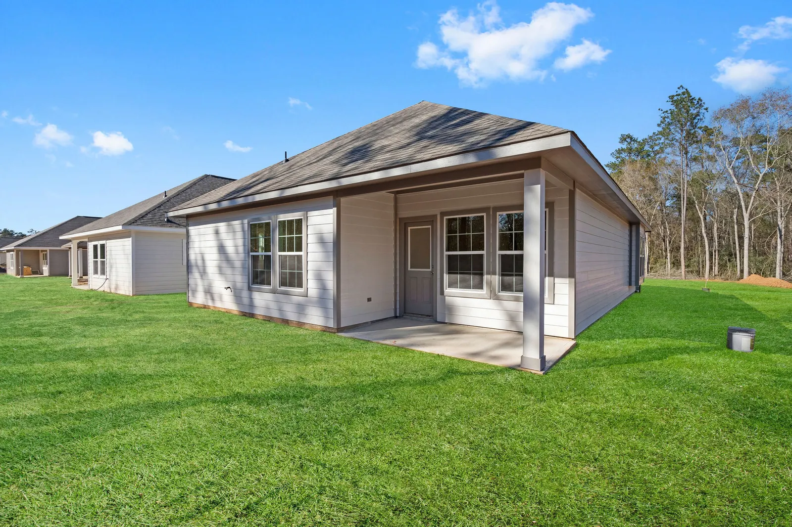 Rear exterior with covered patio at Cedar Crossing by Alta Homes