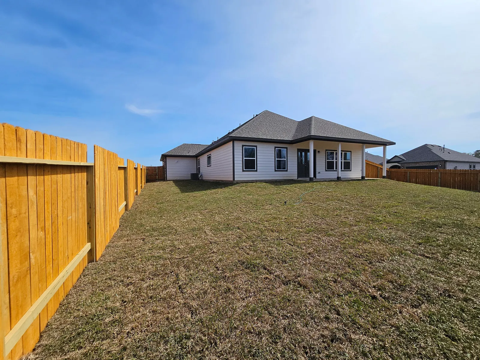 Rear exterior and lawn at 11803 Serena's Song Drive, Willis, TX