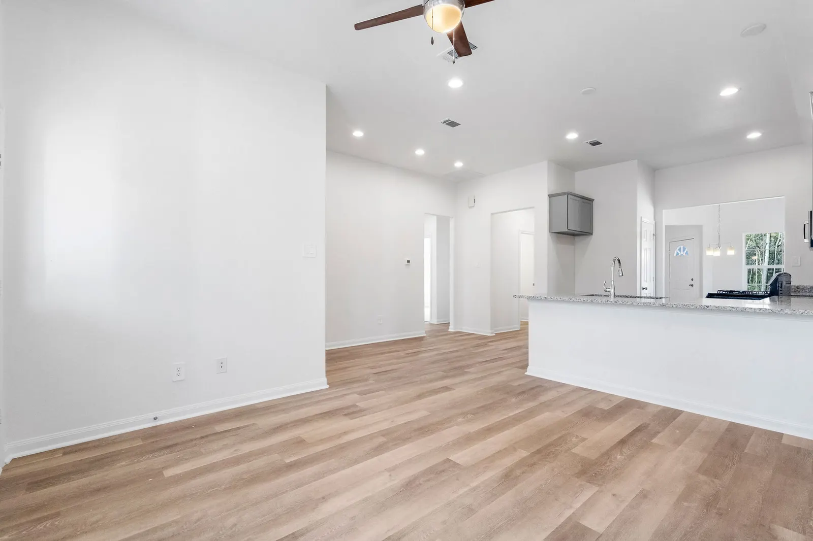 Open living area looking toward the kitchen at Cedar Crossing by Alta Homes