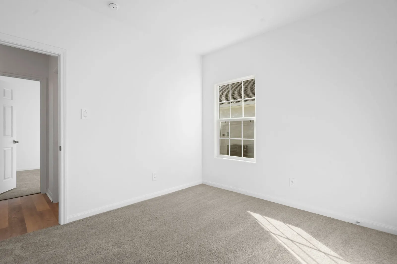Carpeted bedroom at Cedar Crossing by Alta Homes