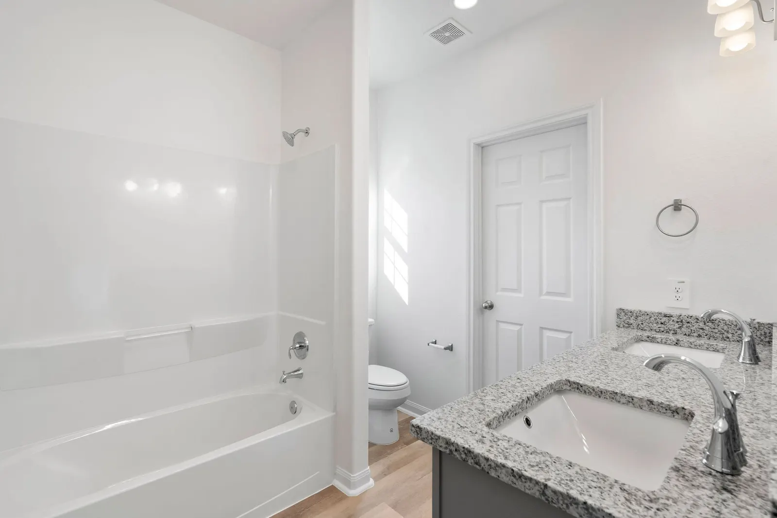 Bathroom with tub, toilet and vanity at Cedar Crossing by Alta Homes